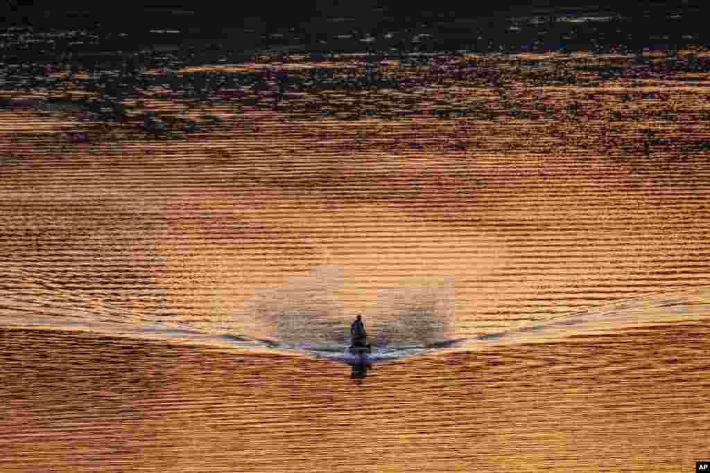 A single bass fishing boat is seen in the Potomac River at sunset in Washington, D.C., April 8, 2020.