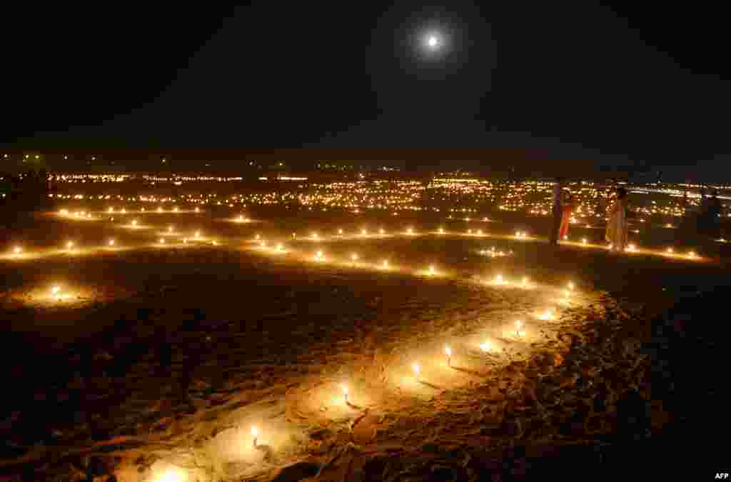 Indian devotees walk at Sangam during the &#39;Dev Deepawali&#39; festival in Allahabad.