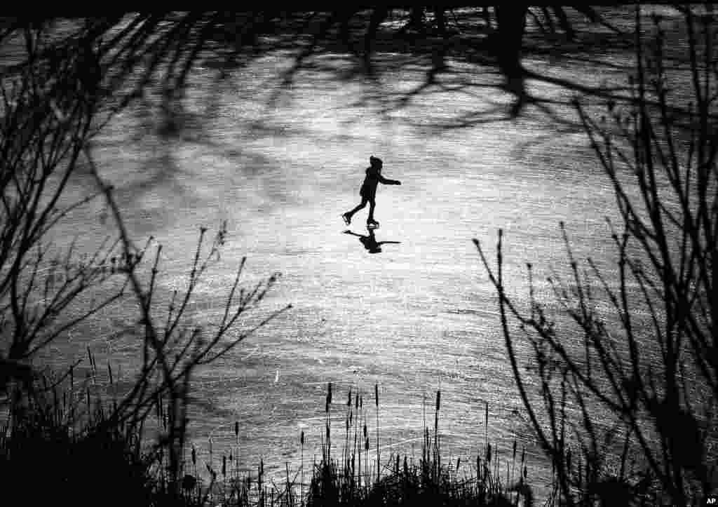 A girl skates across a frozen pond in Freeport, Maine, USA.