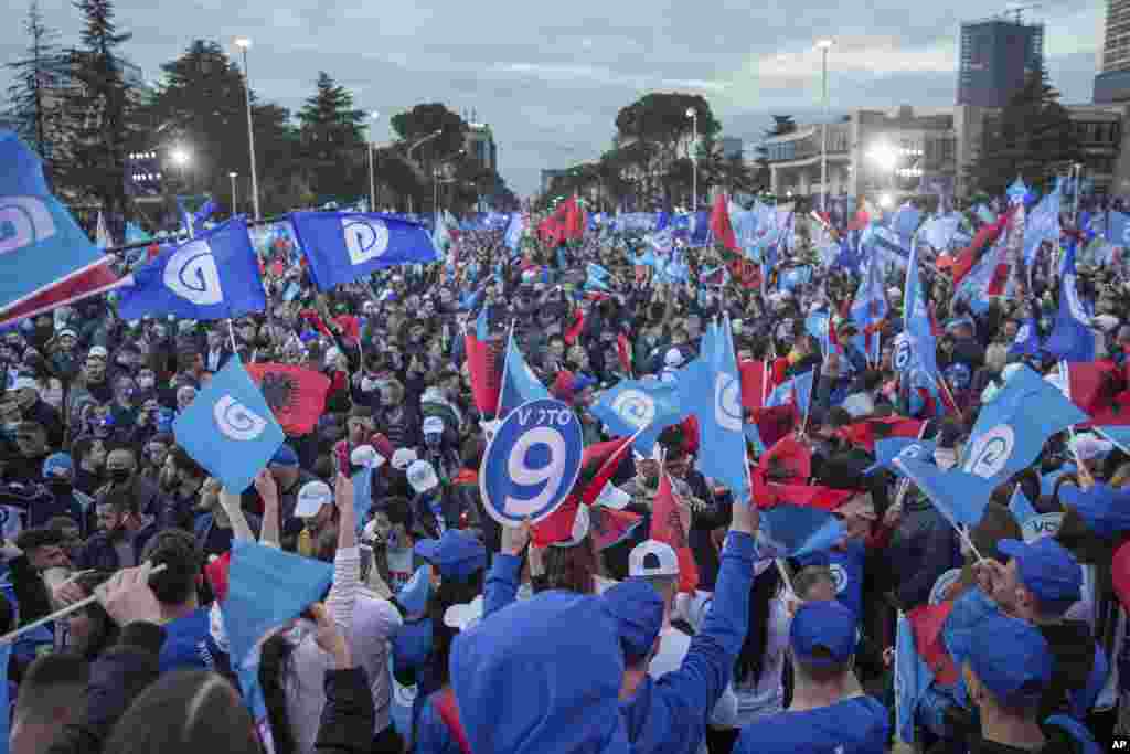 Supporters of the Democratic Party waving Albanian and party flags participate in the political rally in capital Tirana, Albania on Friday, April 23, 2021. Albania holds parliamentary elections on Sunday amid the virus pandemic and a bitter political riva