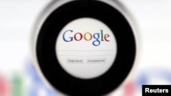 FILE - A Google search page is seen through a magnifying glass in this photo illustration.