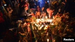 Mourners light candles for the late leader Nelson Mandela, in Johannesburg, South Africa, Dec. 6, 2013.