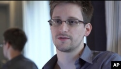 FILE - This photo provided by The Guardian Newspaper in London shows Edward Snowden, who worked as a contract employee at the National Security Agency, June 9, 2013, in Hong Kong.