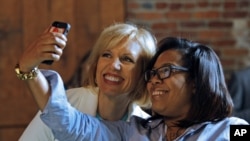 A local small business attendee poses for a selfie with marketing expert Mari Smith at Facebook's Boost your Business Nashville event held at Marathon Music Works on Thursday, Aug. 27, 2015, in Nashville, Tenn. (Photo by Wade Payne/Invision for Facebook/A