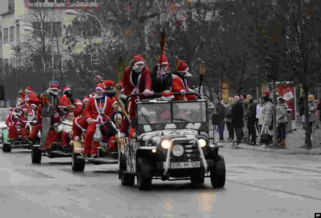 People dressed in Santa Claus costumes celebrate the upcoming New Year and Orthodox Christmas holiday on the main street in Banja Luka, 240 kms northwest of Sarajevo, Bosnia.