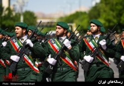 FILE - Iran's Islamic Revolutionary Guards Corps parade through the street in this undated photo.