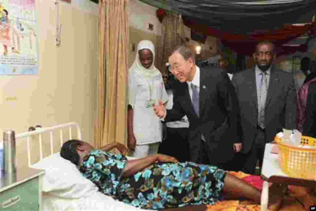 United Nations Secretary-General Ban Ki-moon, center, talks to a patient in a hospital in Abuja, Nigeria, Sunday, May 22, 2011. Ban arrived in Nigeria on Sunday for a two-day visit, weeks after Africa's most populous nation held elections viewed as the fa