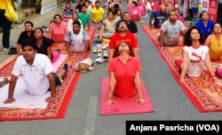A yoga class being held in Gurgaon, near New Delhi is one of hundreds of such sessions which are gaining in popularity in India.