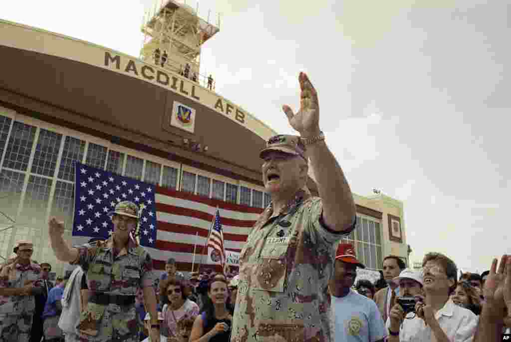 U.S. General Norman Schwarzkopf waves to the crowd after a military band played a song in his honor at welcome home ceremonies at MacDill Air Force Base in Tampa, Florida, April 22, 1991.