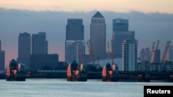 FILE - London's financial district is seen behind the Thames Barrier late afternoon.