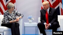 FILE - Britain's Prime Minister Theresa May talks with U.S. President Donald Trump during the G-20 leaders summit in Hamburg, Germany, July 8, 2017.