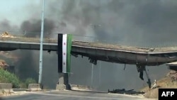 An image grab taken from a video released by the United Nations Supervision Mission in Syria shows smoke rising following shelling from the central flashpoint city of Homs on June 11, 2012. 