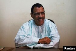 Niger's Foreign Minister Mohamed Bazoum sits at his desk at his political party headquarters in Niamey, Niger, Sept. 14, 2013.