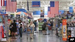 FILE - Customers shop at a Wal-Mart Supercenter store in Springdale, Arkansas.