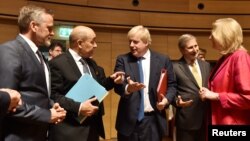 Danish Foreign Minister Anders Samuelsen and French Minister for Foreign Affairs Jean-Yves Le Drian talk with Britain's Foreign Secretary Boris Johnson, European commissioner Johannes Hahn and Austrian Foreign Minister Karin Kneissl during an EU foreign minister meeting in Luxembourg, April 16, 2018.