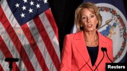 FILE - Education Secretary Betsy DeVos delivers a major policy address on Title IX enforcement, which in college covers sexual harassment, rape and assault, at George Mason University, in Arlington, Virginia, Sept. 7, 2017. 