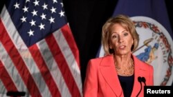 FILE - Education Secretary Betsy DeVos makes remarks during a major policy address on Title IX enforcement, which in college covers sexual harassment, rape and assault, at George Mason University, in Arlington, Virginia, Sept. 7, 2017. 