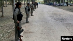 Kurdish Democratic Union Party (PYD) members stand guard during a Labour Day celebration in Efrin May 1, 2014