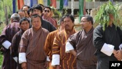 In this photograph taken on July 13, 2013, Bhutanese men wait in line to cast their votes at a polling station in Thimphu. 