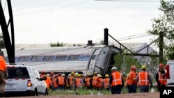 Emergency personnel gather near the scene of a deadly train derailment in Philadelphia, May 13, 2015.