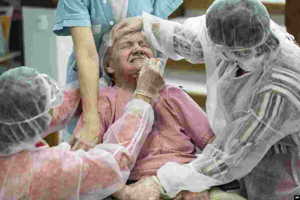 A woman is tested with a PCR COVID-19 test in a nursing home in Ammerschwihr, eastern France.