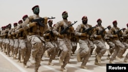FILE - Saudi soldiers march during a military drill in Hafar Al-Batin, Saudi Arabia. 