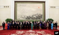 Chinese President Xi Jinping, front center, poses for a group photo with other delegates and guests at the welcoming banquet for the Belt and Road Forum, in Beijing, Sunday, May 14, 2017. (Jason Lee/Pool Photo via AP)