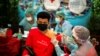 A migrant worker receives his first dose of the Sinopharm vaccine