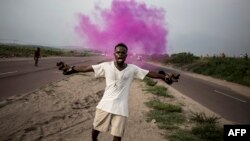 A supporter of Democratic Republic of Congo opposition leader Martin Fayulu reacts after police fire teargas in Kinshasa, Dec. 19, 2018.