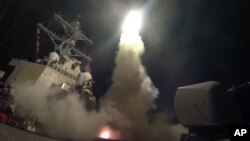 In this image provided by the U.S. Navy, the guided-missile destroyer USS Porter (DDG 78) launches a tomahawk land attack missile in the Mediterranean Sea, Friday, April 7, 2017. The United States blasted a Syrian air base with a barrage of cruise missiles in fiery retaliation for this week's gruesome chemical weapons attack against civilians. (Mass Communication Specialist 3rd Class Ford Williams/U.S. Navy via AP)