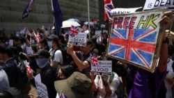 Anti-government protesters hold up banners, placards, Union Jack flags as they gather at the British consulate General in Hong Kong, China, September 15, 2019. (Athit Perawongmetha/Reuters)