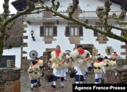 FILE - Bellringers, known as "Joaldunak" in Basque language march with big cowbells hanging on their back during the ancient carnival of Ituren, in the northern Spanish Navarra province, Jan. 28, 2019.