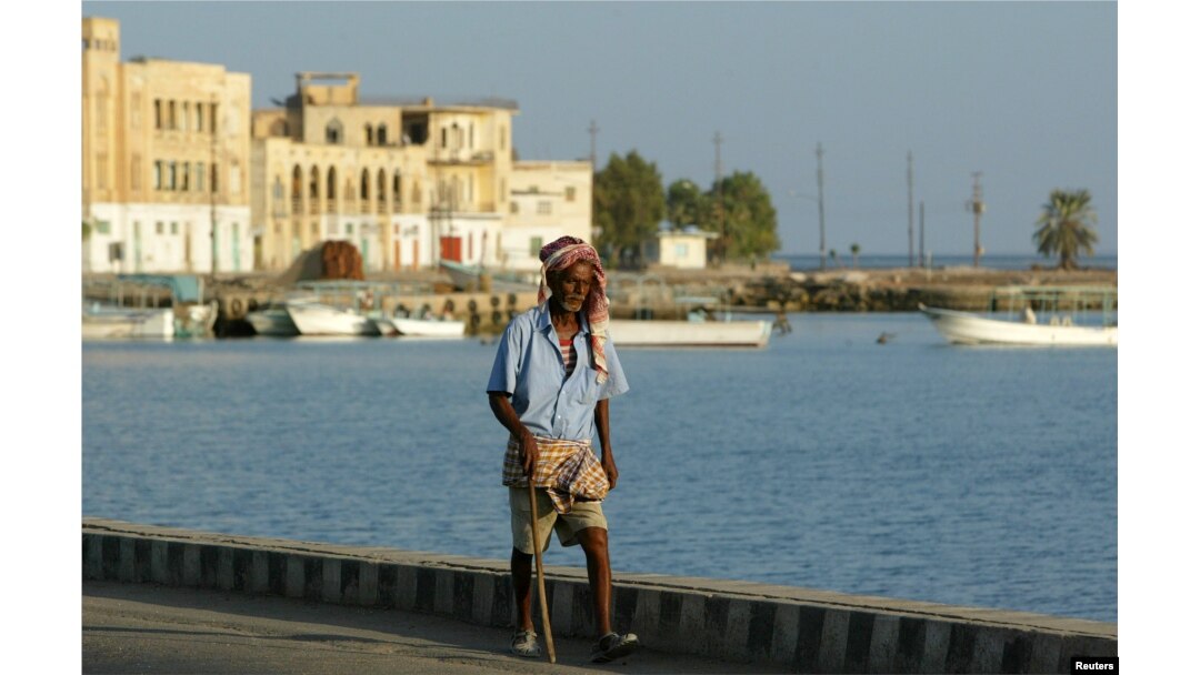 FILE - An Eritrean man walks alongside the Red Sea port of Massawa, 150 kilometers from the capital, Asmara.