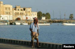 FILE - An Eritrean man walks alongside the Red Sea port of Massawa, 150km from the capital of Asmara.
