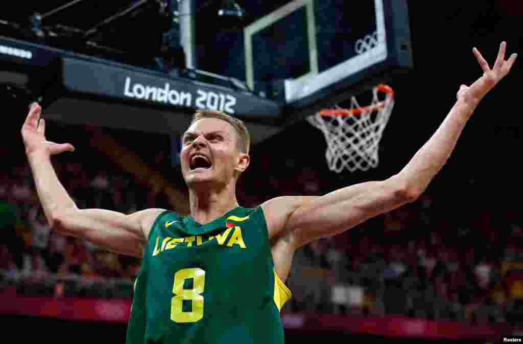 Lithuania's Renaldas Seibutis celebrates a basket against Tunisia during their men's preliminary round Group A basketball match.