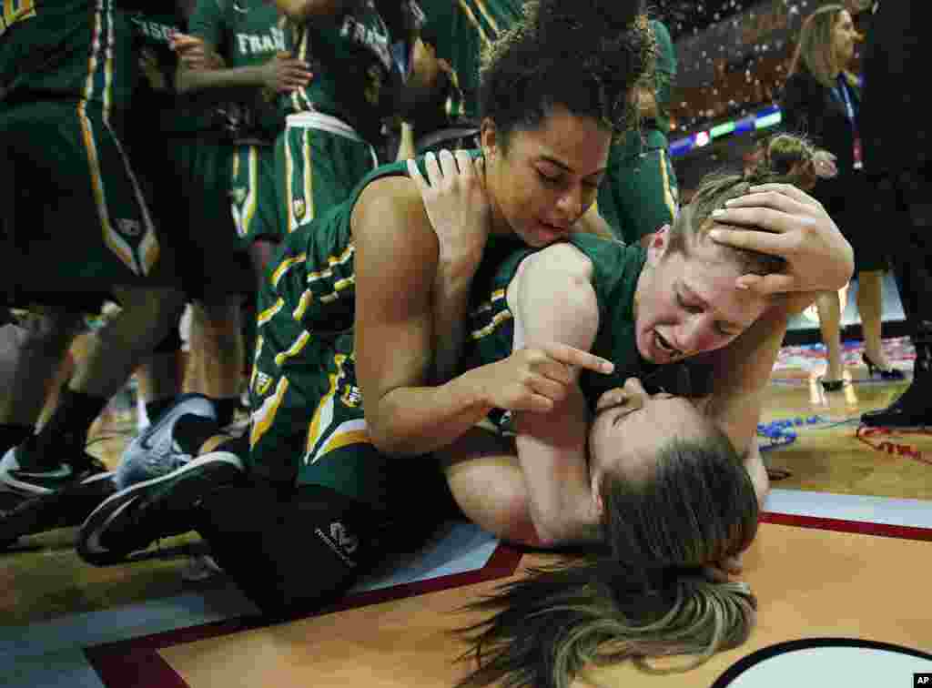 San Francisco guards Zhane Dikes, top, Rachel Howard, center, and forward Taylor Proctor, bottom, celebrate after they defeated Brigham Young University (BYU) in an NCAA college basketball game in the championship of the West Coast Conference tournament in Las Vegas, Nebraska, USA, March 8, 2016.