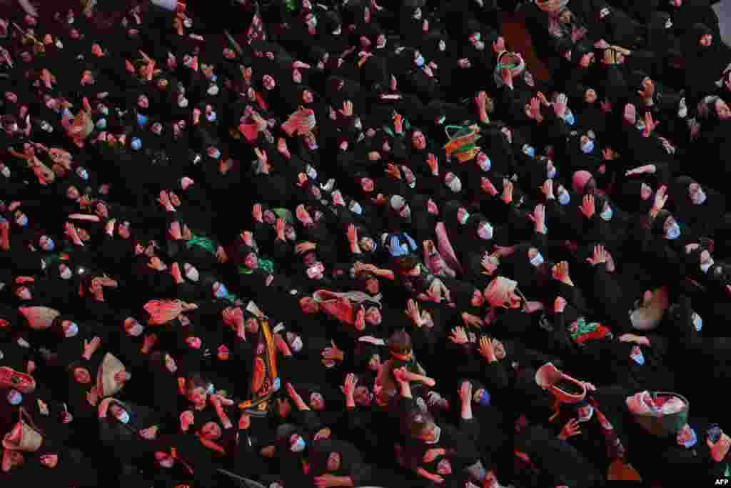 Iraqis take part in a ceremony as part of the Islamic mourning month of Muharram in the holy city of Karbala.