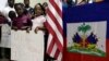 FILE – Standing near U.S. and Haitian flags, youngsters advocate for renewing Temporary Protected Status (TPS) for Central American and Haitian immigrants, at a news conference in Miami, Fla., Nov. 6, 2017.