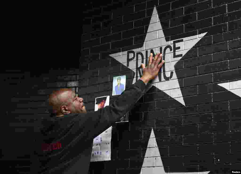 Donnie Straub of Minneapolis touches a star bearing U.S. music superstar Prince's name on an exterior wall of First Avenue, the nightclub where Prince got his start in Minneapolis, Minnesota, April 21, 2016. 