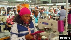 People work on machines at a clothing factory at an industrial town of Newcastle, 260 km southeast of Johannesburg. Taken May 8, 2013.