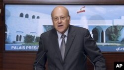 New Lebanese Prime Minister Najib Mikati, speaks after the announcing of the new cabinet, at the Presidential Palace in Baabda, east of Beirut, Lebanon, June 13, 2011