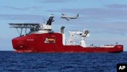 In this April 9, 2014 photo provided by the Australian Defense Force, the Australian Defense vessel Ocean Shield drops sonar buoys to assist in the acoustic search of the missing Malaysia Airliner.