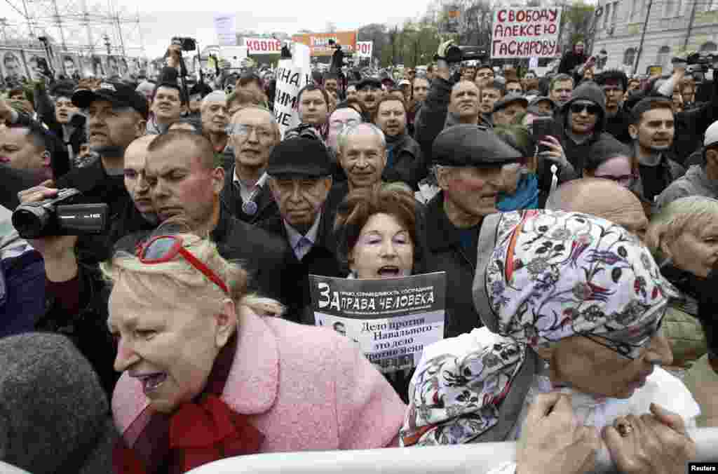 People attend a protest rally in Moscow. Russian protesters unfurled a huge banner demanding the release of &quot;political prisoners,&quot; at the start of a day of protest against President Putin intended to revive their flagging opposition movement.