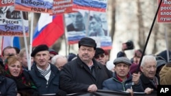 FILE - Russian former opposition lawmaker Gennady Gudkov, center, takes part in a march in memory of opposition leader Boris Nemtsov in Moscow, Russia, Sunday, Feb. 26, 2017.