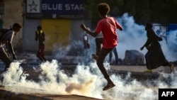 Sudanese youths take to the streets as security forces use tear gas to disperse protesters in the capital Khartoum, Oct. 27, 2021.