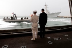 U.S. Vice President Joe Biden, right, watches a maneuver with Cmdr. Tim Wilke, commanding officer of the USS Freedom, the U.S. Navy's first littoral combat ship on rotational deployment at Changi Naval Base, in Singapore Saturday, July 27, 2013.