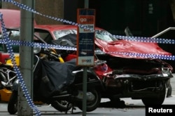 The wreckage of a car is seen as police cordoned off Bourke Street mall, after a car hit pedestrians in central Melbourne, Australia, Jan. 20, 2017.