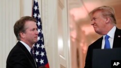 President Donald Trump shakes hands with Judge Brett Kavanaugh his Supreme Court nominee, in the East Room of the White House, July 9, 2018, in Washington. 