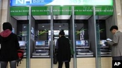 Customers use ATM machines at a Nonghyup bank in Seoul, South Korea, May 3, 2011