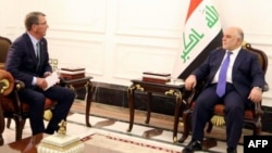 A handout picture shows Iraqi Prime Minister Haidar al-Abadi (R) meeting with U.S. Secretary of Defense Ash Carter in Baghdad, Oct. 22, 2016. Carter says he has worked out the outlines of a deal to ease tensions between Iraq and Turkey.